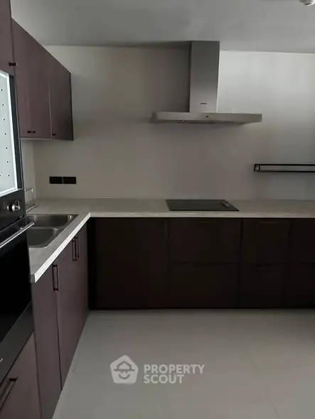 Modern kitchen with sleek cabinetry and built-in appliances