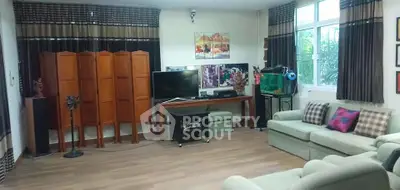 Spacious living room with modern decor, large windows, and comfortable seating, perfect for relaxation and entertainment.