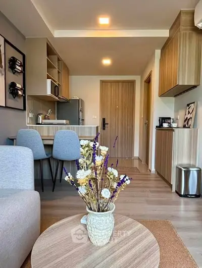 Modern open-layout living room with stylish kitchen and cozy decor