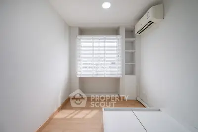 Bright minimalist bedroom with air conditioning and wooden flooring