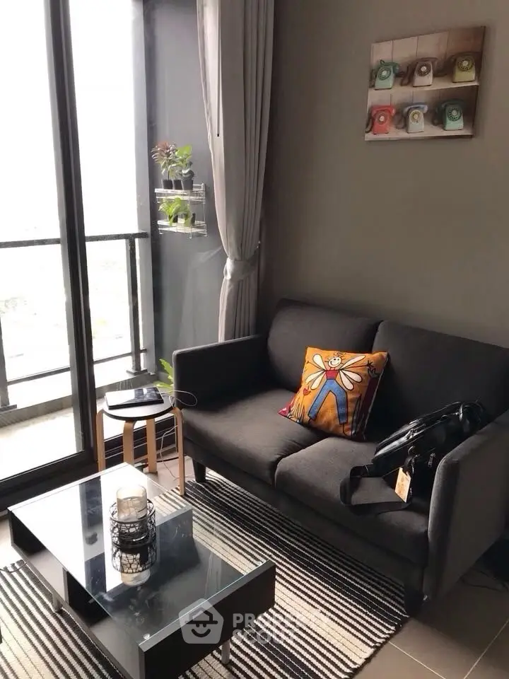 Chic modern living room with cozy sofa and balcony view, perfect for urban living.