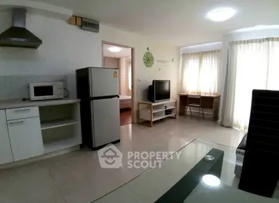 Spacious living area with modern kitchen and natural light