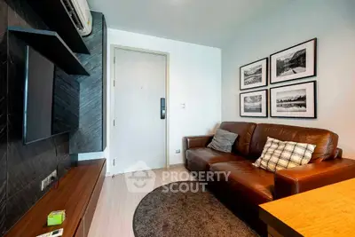 Cozy living room with leather sofa and wall art, modern interior design.