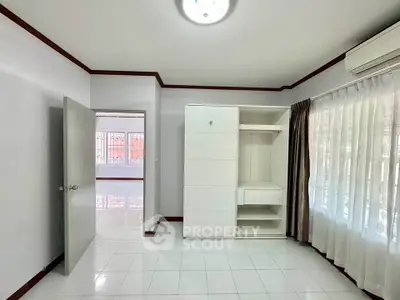 Spacious bedroom with built-in wardrobe and natural light