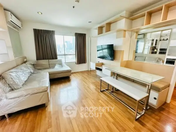 Spacious modern living room with hardwood floors and city view