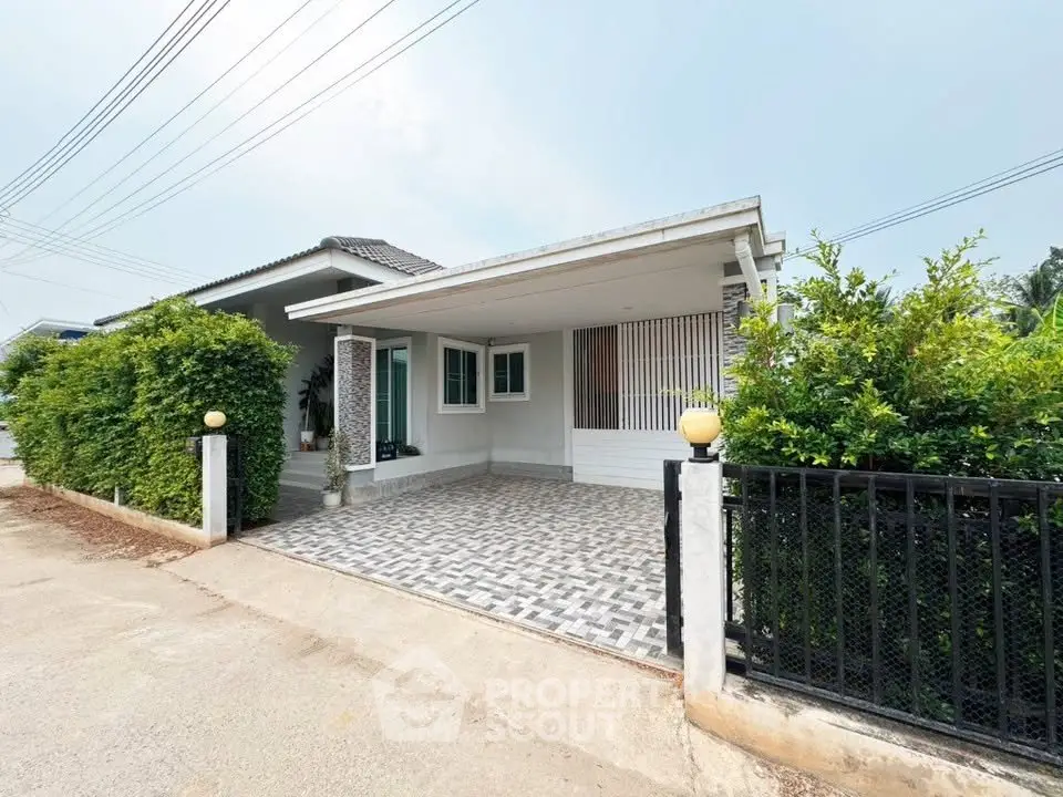 Charming single-story home with modern exterior and spacious driveway