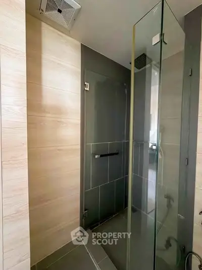 Modern bathroom with glass shower enclosure and sleek tile design