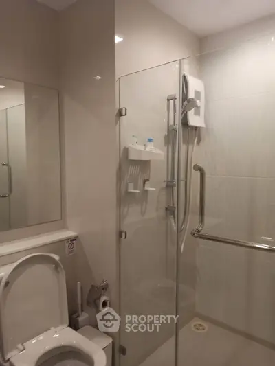 Modern bathroom with glass shower enclosure and sleek fixtures