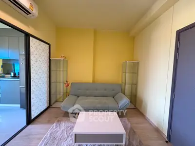 Modern living room with stylish sofa and glass cabinets in cozy apartment