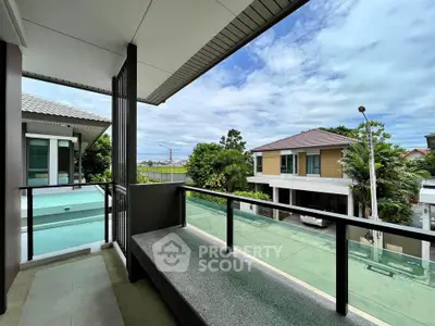 Spacious balcony with modern railing and serene neighborhood view