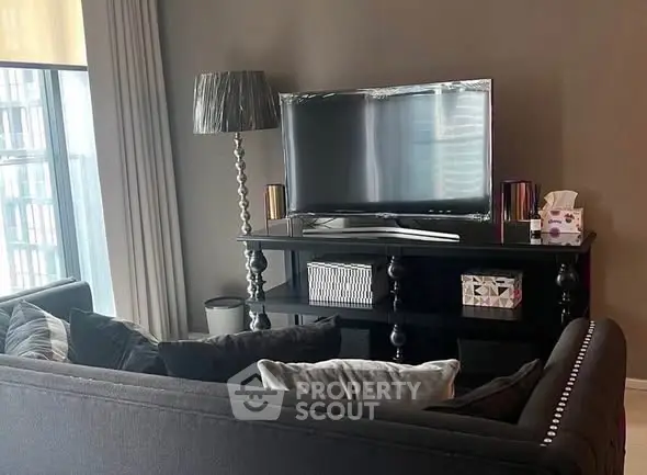 Stylish living room with modern TV setup and elegant decor.