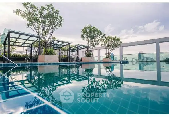 Luxurious rooftop pool with stunning city views and lush greenery, perfect for relaxation and leisure.