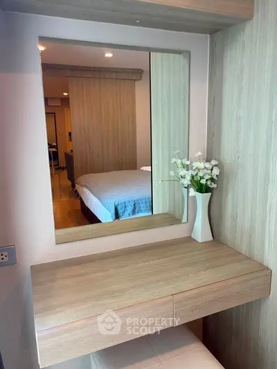 Stylish bedroom with modern vanity and elegant decor in a cozy apartment.