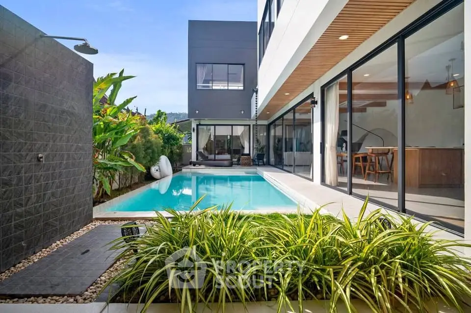 Modern luxury home with private pool and lush garden, perfect for relaxation and entertaining.