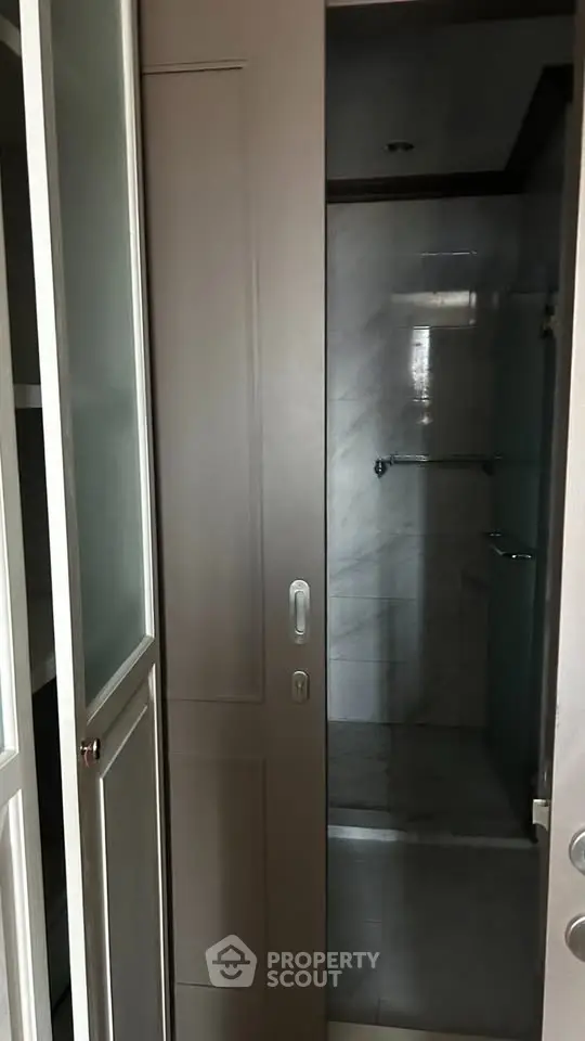 Modern bathroom with sliding door and sleek marble tiles