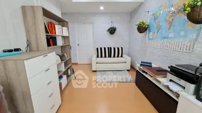 Charming study room with cozy sofa and world map decor, perfect for productivity and relaxation.