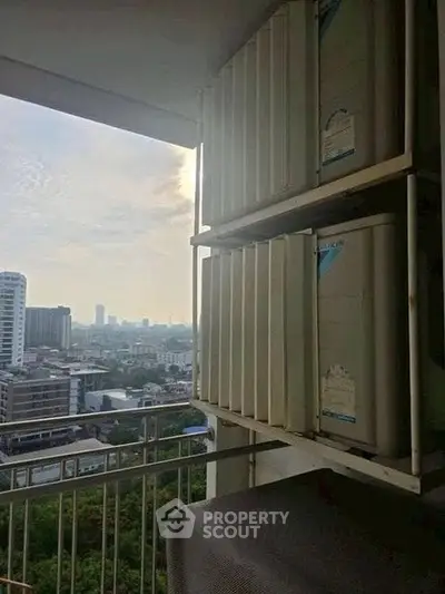 High-rise building balcony with city view and air conditioning units