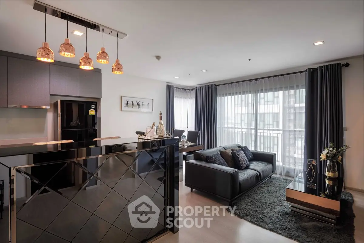 Modern living room with stylish decor and large windows in a contemporary apartment.