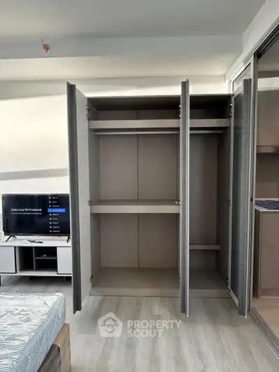 Spacious bedroom with open wardrobe and modern decor