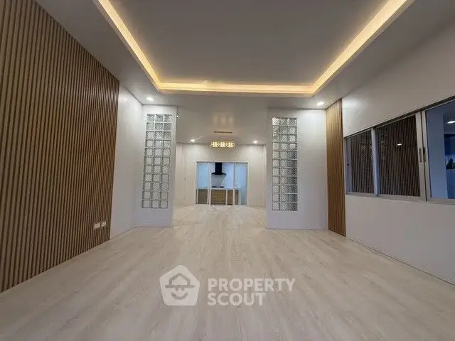 Spacious modern living room with elegant lighting and wooden accents