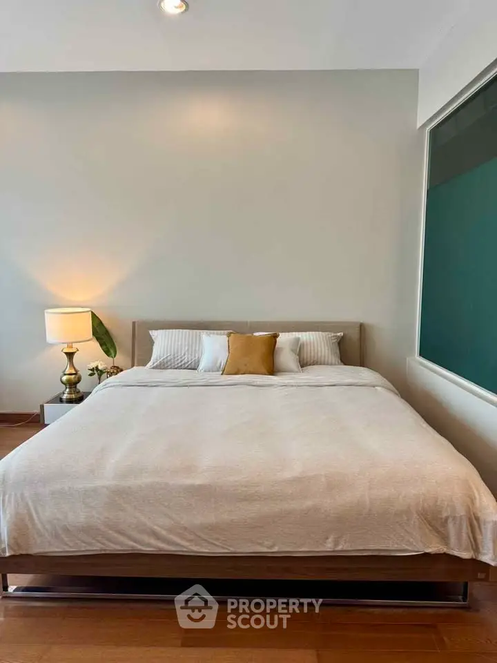 Spacious bedroom with modern decor and cozy ambiance