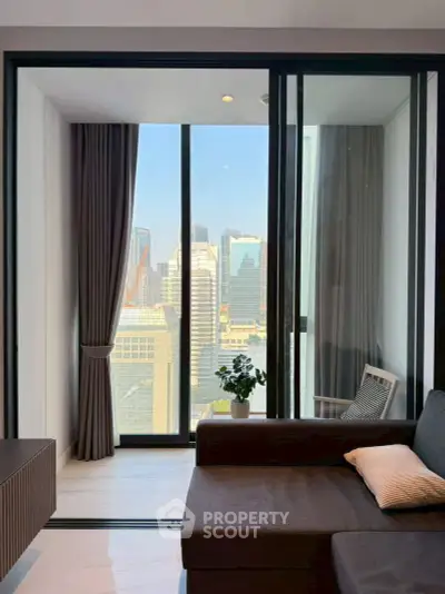 Modern living room with stunning city view through large glass windows, featuring sleek furniture and elegant decor.