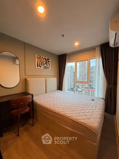 Modern bedroom with city view, featuring stylish decor and ample natural light.