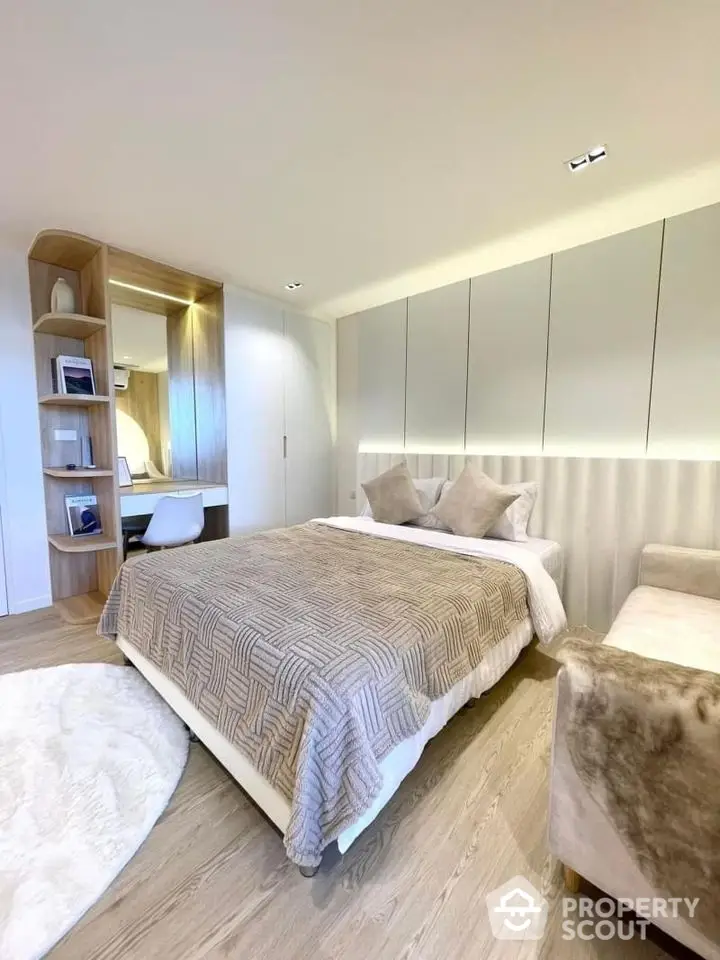 Modern bedroom with cozy decor and elegant lighting in a stylish apartment.