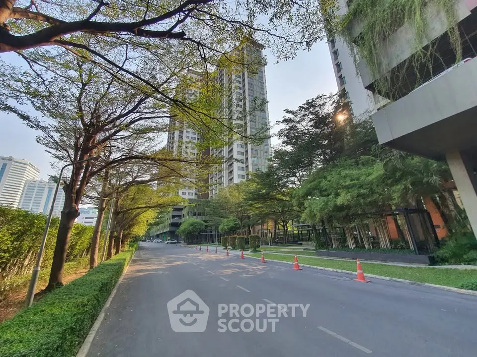 Stunning high-rise building with lush greenery and serene street view