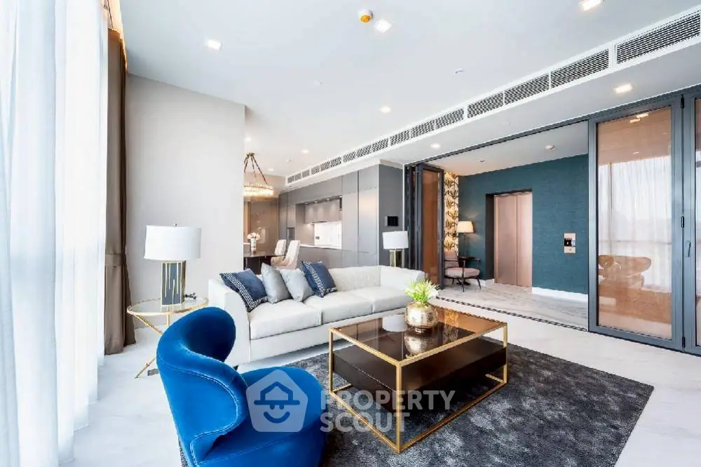 Luxurious modern living room with elegant decor and open kitchen layout.