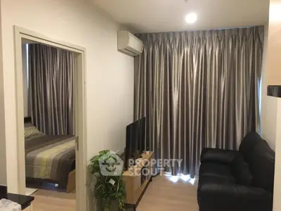 Cozy living room with modern decor and adjacent bedroom, perfect for urban living.