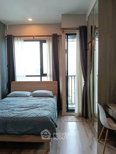 Modern bedroom with large windows and stylish decor in a high-rise apartment.