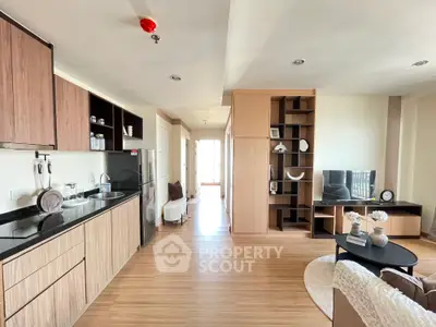 Modern open-plan living room with sleek kitchen and stylish decor
