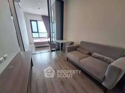 Modern apartment interior with cozy living room and bedroom, featuring stylish furniture and large windows.