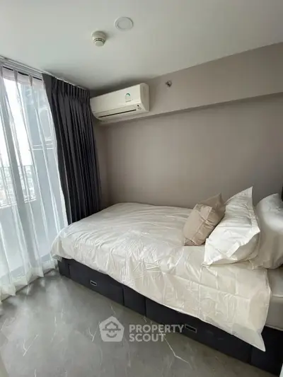 Modern bedroom with sleek design, featuring a comfortable bed and air conditioning, perfect for urban living.