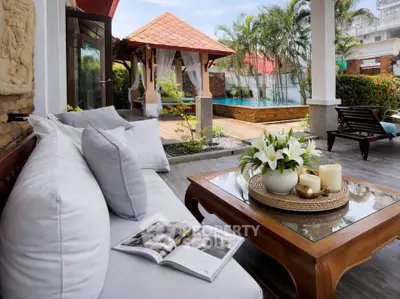 Luxurious outdoor patio with poolside view and elegant seating area