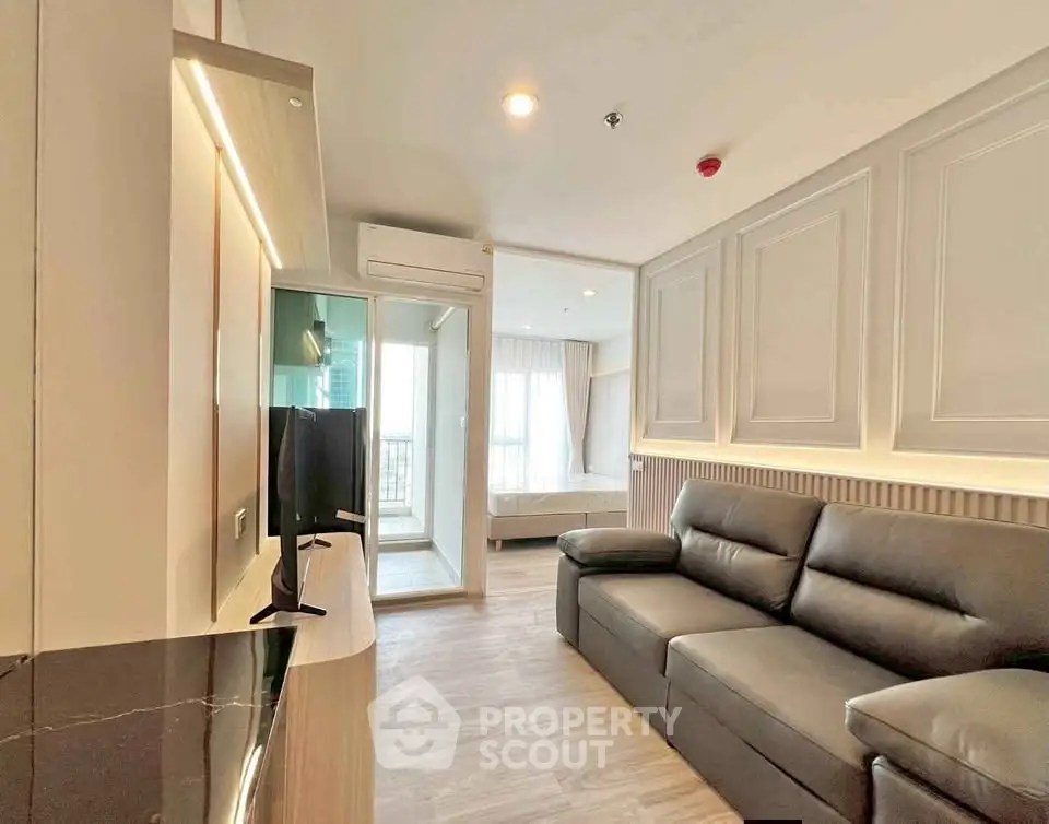 Modern living room with sleek design and natural light, featuring a cozy sofa and stylish decor.