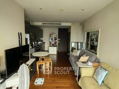 Spacious living room with modern decor and open kitchen layout, perfect for urban living.