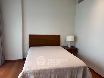 Cozy bedroom with wooden flooring and modern furniture