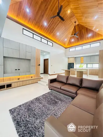 Luxurious modern living room with high wooden ceiling and stylish furniture