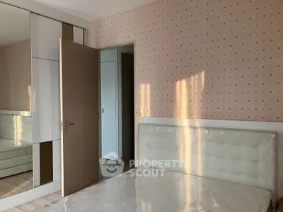 Spacious bedroom with modern wardrobe and elegant headboard, perfect for comfort and style.