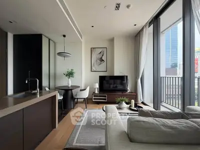 Modern living room with open kitchen and large windows in a high-rise apartment