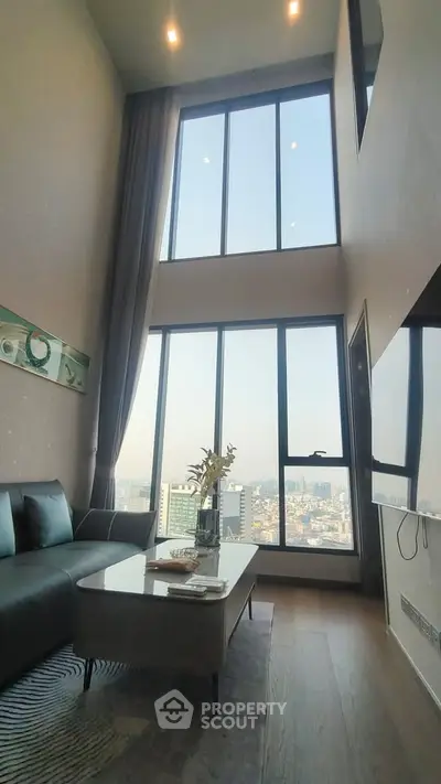 Luxurious high-ceiling living room with panoramic city views and modern decor