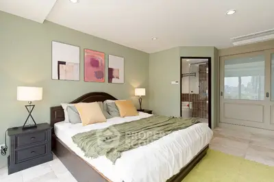 Spacious bedroom with modern decor and ensuite bathroom in luxury apartment