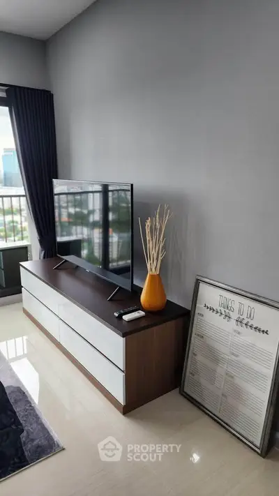 Modern living room with sleek TV stand and balcony view