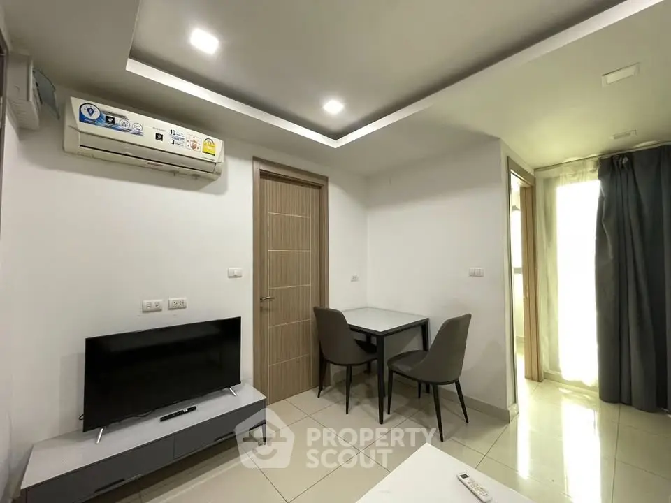 Modern living room with sleek furniture and air conditioning in a contemporary apartment.