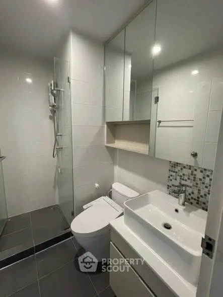 Modern bathroom with sleek fixtures and glass shower enclosure