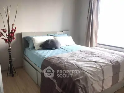 Cozy bedroom with modern decor and large window for natural light