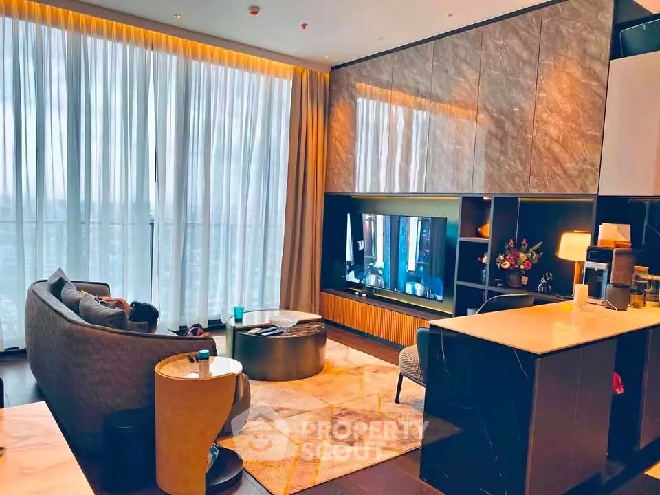 Luxurious modern living room with floor-to-ceiling windows and elegant furnishings.