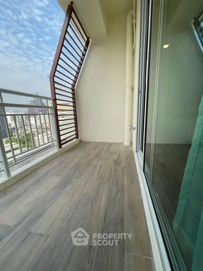 Spacious balcony with modern railing and city view, perfect for relaxation.